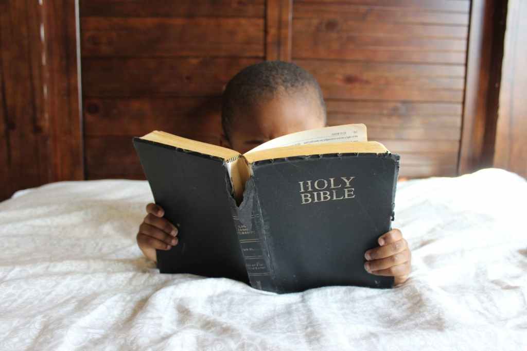 A Boy Reading the Holy Bible 